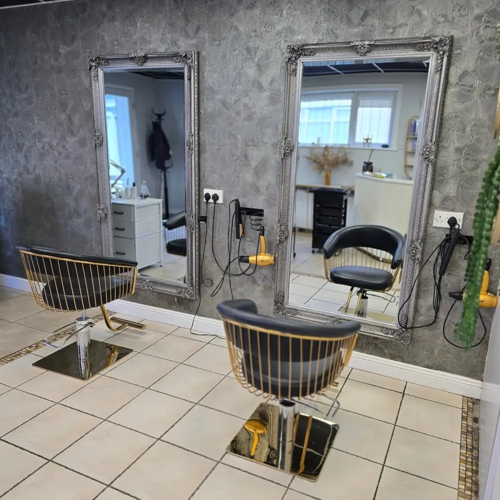 Inside Indigo Hair & Beauty, gold styling chairs and ornate mirrors on Pearse Street